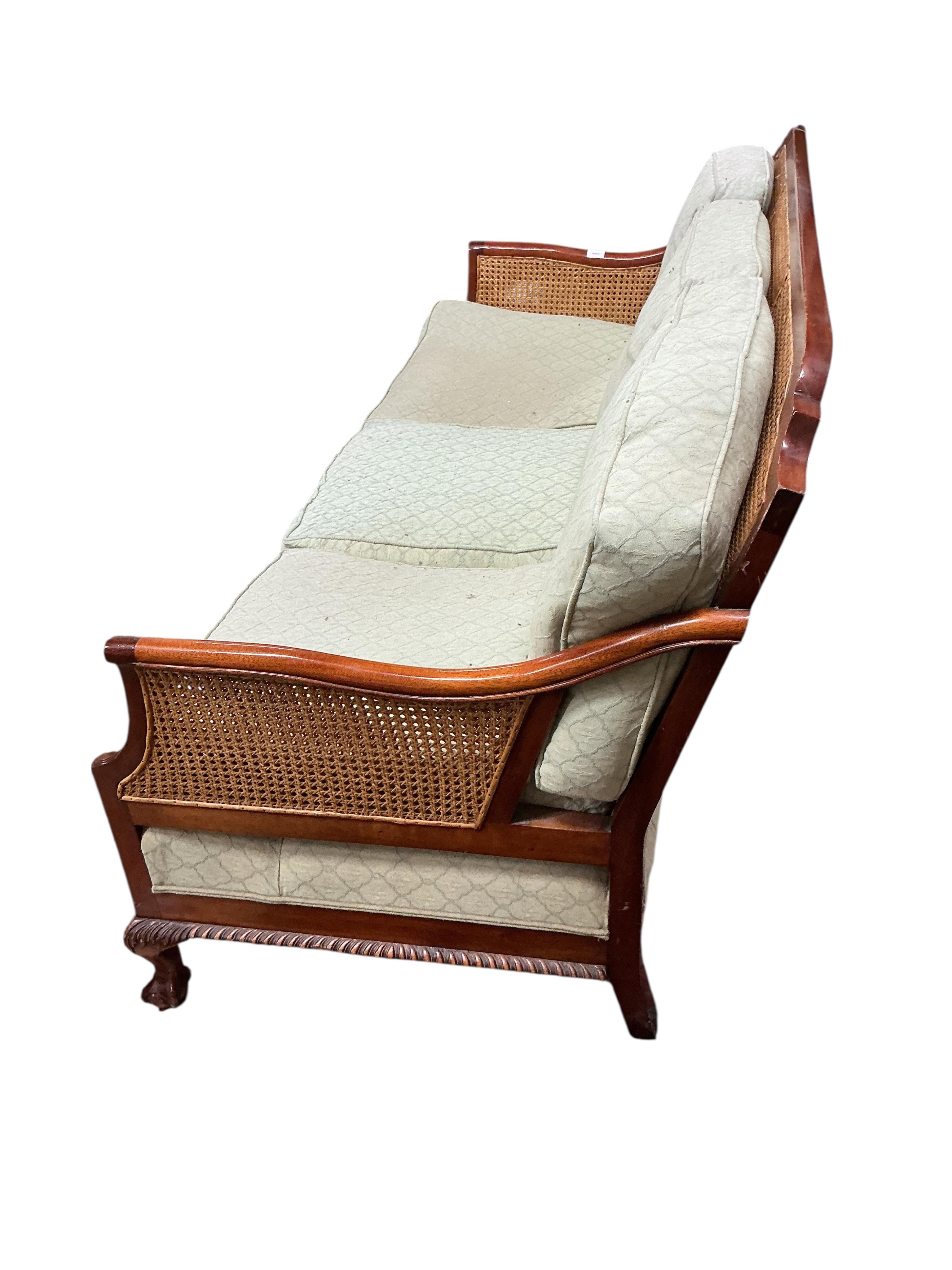 A mahogany double caned bergere settee with loose cushion seat and back, width 178cm, depth 78cm, height 87cm